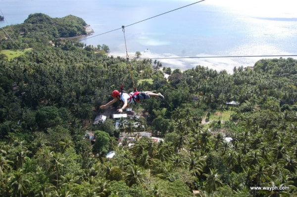 Zipping the 1.3 kilometer zipline at Dakak Beach Resort Adventures ...